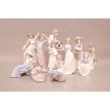 Ten modern Nao porcelain figures, the tallest a girl tying her hair, 30cm, together with a Lladro