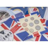 A collection of Royal Mint and other UK coin sets and individual coins, together with some loose