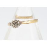 An 18ct gold and platinum old cut diamond solitaire, the circular stone in illusion setting on a