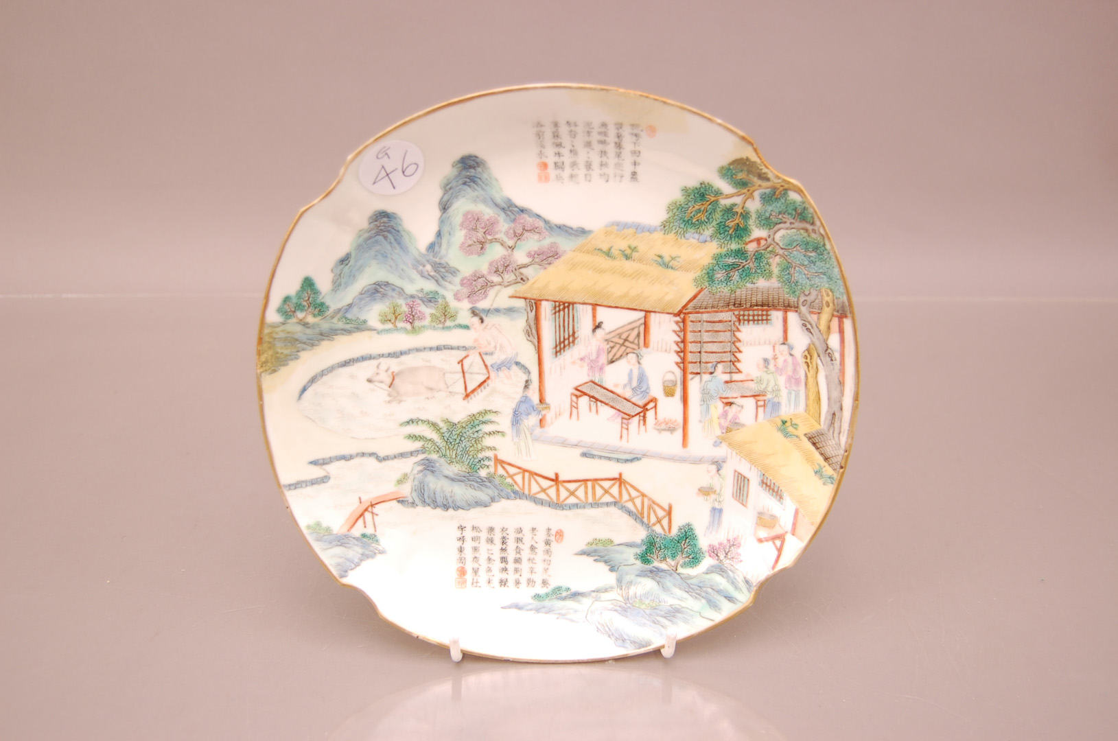 A late 19th century Chinese porcelain plate, 24cm, three areas restored, with figures in an interior