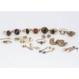 A collection of gold rings and other yellow metal items, including tigers eye, carnelian, pearls and