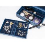 A blue leatherette jewellery case, containing various items of costume jewellery including a pair of