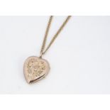 A gold fronted and back Edwardian heart shaped locket, with engraved floral and songbird
