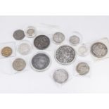 A collection of coins and reproduction coins, including an 1887 half crown, florin and shilling,