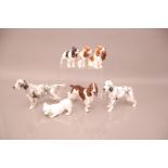 A group of seven pottery and porcelain dogs, including a Royal Copenhagen West Highland terrier,