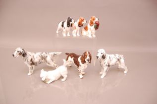 A group of seven pottery and porcelain dogs, including a Royal Copenhagen West Highland terrier,