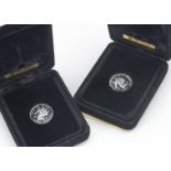 Two 1970s Pobjoy Mint Isle of Man platinum £1 coins, each dated 1979, in black boxes, one removed