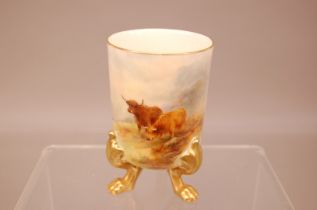 An early 20th century Royal Worcester porcelain vase, cylindrical beaker on three four paw gilt