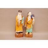 A pair of early 20th century Chinese pottery polychrome glazed figures, tallest 38cm but has had