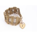 A 9ct gold nine bar gate link bracelet, with padlock heart shaped clasp, 18cm, 29.5g