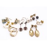 A quantity of gold pearl and gem set earrings, including mother of pearl, topaz and garnet, total