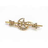 An Edwardian 15ct gold seed pearl set bar brooch, decorated with sickle moon and star with ivy