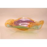 A large Studio Glass Contour Range centrepiece bowl by Bob Crooks, 69cm wide, in amber with greens