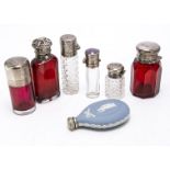 Seven Victorian and 20th century scent bottles, three red examples with silver caps, one stopper