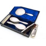 A late Victorian six piece silver dressing table set, in fitted box, with engraved family crest,