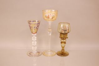 Three late 19th and early 20th century German enamelled glasses, the tallest, 27cm, with cut and