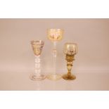 Three late 19th and early 20th century German enamelled glasses, the tallest, 27cm, with cut and