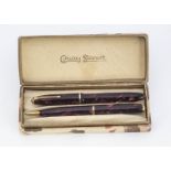 A vintage Conway Stewart 550 fountain pen and pencil set, in mottled red, boxed (3)