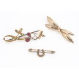 A continental yellow metal filigree bow brooch, having 14ct gold strike marks, 3.2g and two other