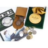 A collection of World coins and medallions, including a 1985 Mexico World Cup coin on card, a set of