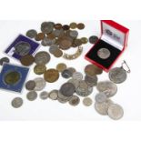 A small collection of coins, including a double headed US dollar style coin, a 1925 East Africa 1