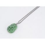 A Chinese jadeite jade pierced pendant, modelled as a bat supporting a pierced disc with a white