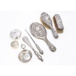 A George V silver tobacco pocket pot and other items of silver, including a vesta case, serviette