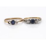 A three stone sapphire and diamond dress ring, central circular cut sapphire flanked by two