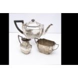 A late Victorian silver three piece tea set by William Hutton & Sons, with teapot, milk jug and