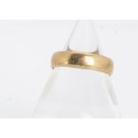 A 22ct gold wedding band, of flattened form, with slightly curved profile, 5mm thick, ring size R,