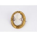 A 19th Century shell carved cameo, in bass relief full face of oval shape within a yellow metal