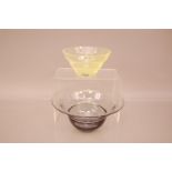 Two Kosta Boda Glass bowls, one in smoky grey, 20.5cm, the other yellow (2)