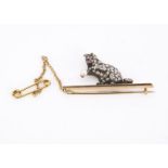 An Edwardian diamond encrusted pussy cat bar brooch, the rose cut diamonds set in silver with ruby