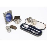 A small group of silver and other items, including a small silver tyg, a silver ingot on chain,