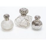 Three Victorian and later glass and silver mounted scent bottles, the largest 13cm high with