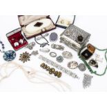 A collection of costume jewels, including a paste Art Deco style brooch, a string of Chinese