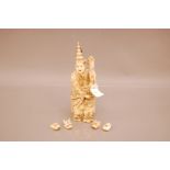 A Japanese late Meiji period carved ivory figure of an entertainer with four masks, 22cm, well