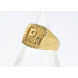 A continental yellow metal 18ct marked gentleman's signet ring, the cushion shaped textured tablet