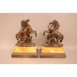 A pair of second half 19th century bronze Marley horses, 26cm high, with figure of a man trying to