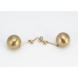 A pair of yellow metal sphere drop earrings, the textured sphered on plain baton links with post