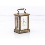 A miniature brass carriage timepiece, 8cm with handle up, marked Matthew Norman London, not running