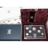 A collection of Royal Mint UK Deluxe and Proof coin sets, with 22 sets from the 1990s and two from