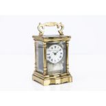 A Victorian brass carriage timepiece, 15cm high with handle up, dial cracked, marked Stewart