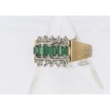 An emerald and diamond dress ring, the five graduated central set emeralds flanked by bands of