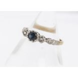 A three stone sapphire and diamond 18ct gold dress ring, the circular mixed cut sapphire in claw