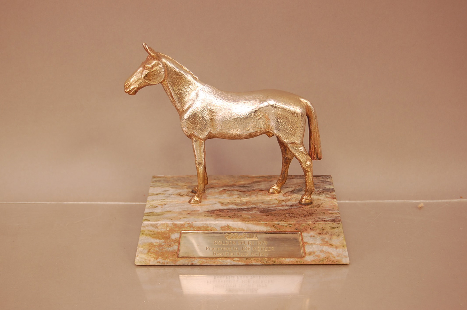A 1970s silver plate and hardstone horseracing trophy, 15cm wide, the rectangular base with engraved
