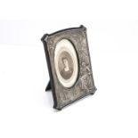 An Edwardian silver mounted photograph frame from M & C Ltd, 22.5cm high, with nice raised design of