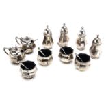 An Art Deco silver cruet set, comprising four octagonal form peppers, and salts with blue glass