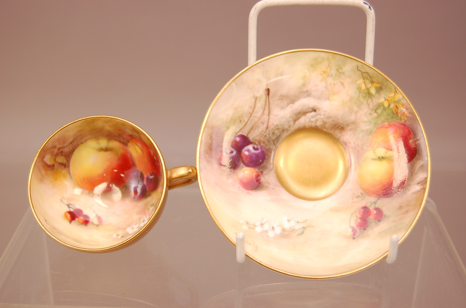 An early 20th century Royal Worcester Porcelain cabinet teacup and saucer, with painted apples,