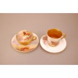 Two early 20th century Royal Worcester porcelain cabinet cups and saucers, differing shapes, both